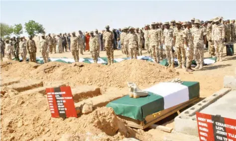  ??  ?? Burial ceremony of soldiers who died during the insurgency battle with Boko Haram members at the Maimalari Cantonment cemetery in Maiduguri yesterday Olatunji Omirin
