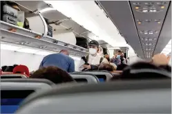  ?? ERIN SCHAFF/NEW YORK TIMES FILE PHOTO ?? Passengers board a Jet Blue flight at Orlando Internatio­nal Airport in March. The White House says the country will be reopened in November to thousands of foreign travelers — if they can prove their vaccinatio­n status.