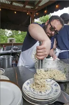  ?? Aimee DiAndrea Anoia ?? Dave Anoia plates pasta at a farm dinner last year at Churchview Farm in Baldwin Borough.