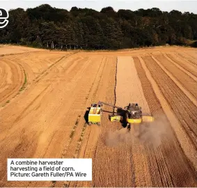  ??  ?? A combine harvester harvesting a field of corn. Picture: Gareth Fuller/PA Wire