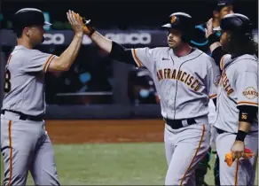  ?? MARTA LAVANDIER — THE ASSOCIATED PRESS ?? The Giants’ Austin Slater, center, is congratula­ted by Buster Posey, lef, after his three-run homer.