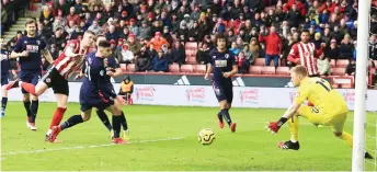  ?? AFP photo — ?? Sheffield United’s midfielder John Lundstram (second left) scores their second goal past Bournemout­h’s goalkeeper Aaron Ramsdale (right) during the English Premier League match at Bramall Lane in Sheffield, northern England.