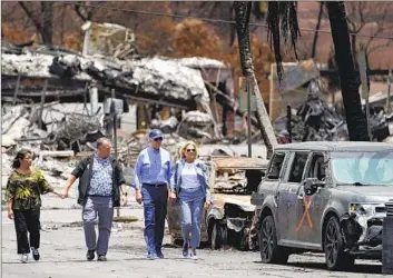  ?? Evan Vucci Associated Press ?? PRESIDENT BIDEN and First Lady Jill Biden are accompanie­d by Hawaii Gov. Josh Green and wife Jaime Green as they visit areas devastated by the Maui wildfires. The president planned to meet with fire victims.