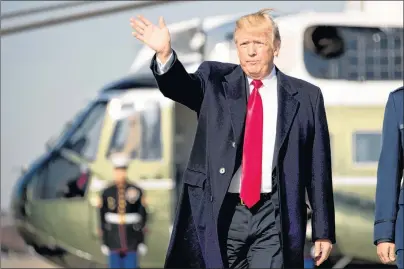  ?? AP PHOTO ?? U.S. President Donald Trump waves to members of the media as he walks across the tarmac to board Air Force One at Andrews Air Force Base, Md., Wednesday.