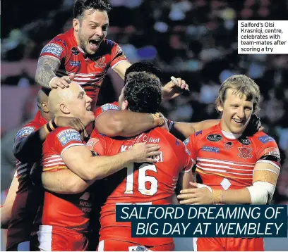  ??  ?? Salford’s Olsi Krasniqi, centre, celebrates with team-mates after scoring a try