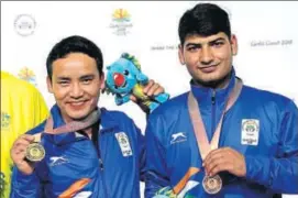  ?? AP ?? Jitu Rai and Om Mitharval, who won bronze, after receiving their medals at the Belmont Shooting Centre in Brisbane on Monday.
