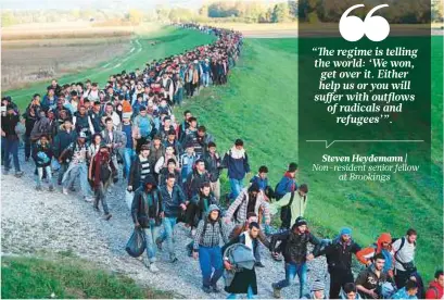  ?? Reuters ?? Syrian refugees make their way on foot on the outskirts of Brezice, Slovenia, in 2015. Thousands of Syrians fled their country’s civil war to Europe to secure a better future for their families.