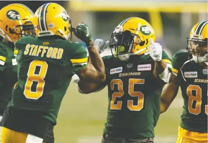  ?? IAN KUCERAK ?? Eskimos running back Shaquille Cooper, centre, celebrates with teammates after scoring a touchdown in Edmonton’s 26-0 win over the winless Toronto Argonauts on Thursday night. Cooper rambled for a career high 128 rushing yards and a touchdown on 22 carries.