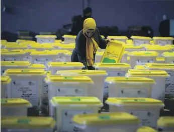  ?? Reuters ?? An election official checks ballot boxes at a vote counting centre in Amman on Sunday