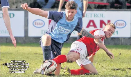  ??  ?? ● Llanrug’s Marvin Pritchard wins this sliding tackle against Greenfield