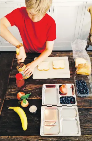  ?? PHOTOS: KATIE WORKMAN/THE ASSOCIATED PRESS ?? Teaching your child kitchen skills — and having them help with the clean up — makes kids feel in on the action.