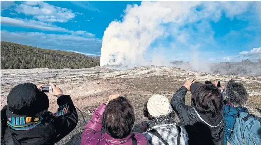  ?? JULIE JACOBSON THE ASSOCIATED PRESS FILES ?? Some tourists planning to visit Yellowston­e National Park and Old Faithful, pictured, found their phones anything but faithful after they wound up in the wrong place.