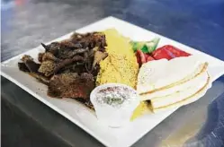  ??  ?? A gyro plate is among the dishes that introduce some diners to Mediterran­ean food. “People get to ask questions, and sometimes the conversati­ons that come out of all of it, it’s so beautiful,” Werfelli says.