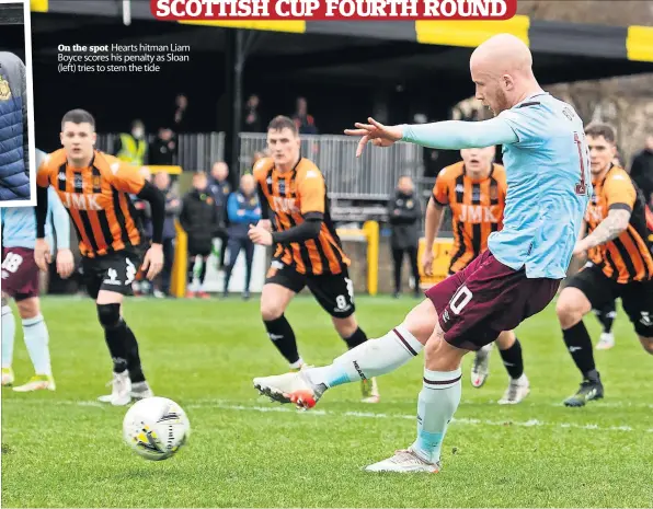  ?? ?? On the spot Hearts hitman Liam Boyce scores his penalty as Sloan (left) tries to stem the tide