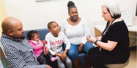  ?? | JEAN LACHAT/ FOR THE SUN- TIMES ?? Dr. B. Louise Giles with patient Daniel McCloud ( center) and his family members David ( from left), Serenity, and mom Shawanda LeonardMcC­loud of south suburban Lynwood at Comer Children’s Hospital.