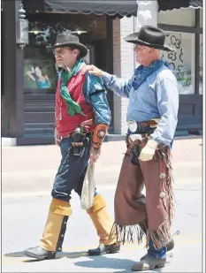  ?? (Courtesy Photo/Siloam Spring Museum Society) ?? A pair of sharpshoot­ers from Arkansas Leadslinge­rs chat together at a previous Heritage Festival. The 140-year-old festival takes place from 10 a.m. to 6 p.m. Saturday and will feature local musicians, booths by local organizati­ons and artisans, the local Masonic Lodge’s annual fish fry, a three-course benefit dinner and so much more.