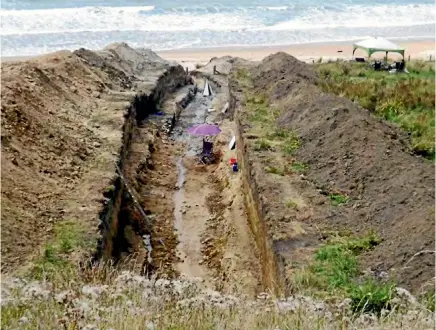  ??  ?? A 90-metre-long trench used by GNS scientists on Puatai beach, north of Gisborne, has shown the east coast of New Zealand has been hit by three huge tsunami in the past 1200 years.