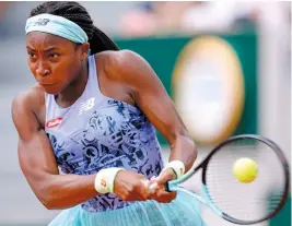  ?? — AP ?? Coco Gauff of USA returns to Belgium’s Alison Van Uytvanck during their French Open second round match at the Roland Garros Stadium in Paris on Wednesday.