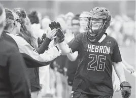  ?? BRIAN KRISTA/BALTIMORE SUN MEDIA GROUP ?? Mount Hebron goalie Georgia Ryan smiles as she leads her teammates in the handshake line following their win over Huntingtow­n during a state semifinal.