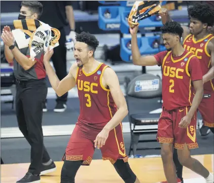  ?? PAUL SANCYA — THE ASSOCIATED PRESS ?? USC forward Isaiah Mobley (3) celebrates defeating Kansas 85-51 in the second round of the NCAA Tournament in Indianapol­is on Monday.