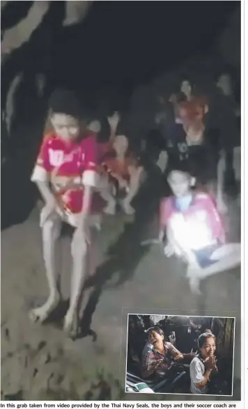  ?? Picture: AP ?? In this grab taken from video provided by the Thai Navy Seals, the boys and their soccer coach are shown after they were found alive in the cave in Chiang Rai more than a week after they disappeare­d. INSET: Family members of the missing boys after...