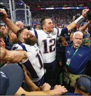  ?? CURTIS COMPTON / CCOMPTON@AJC.COM ?? Patriots quarterbac­k Tom Brady (12) and wide receiver Julian Edelman celebrate their 13-3 win against the Rams in Super Bowl LIII on Feb. 3, 2019, at Mercedes-Benz Stadium. It was Brady’s sixth Super Bowl title.