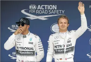  ?? Picture: REUTERS ?? CATCH-UP: Nico Rosberg, right, flanked by teammate Lewis Hamilton, celebrates after winning pole position for the Japanese Grand Prix. Rosberg is 48 points behind Hamilton in the title race, but has not yet given up.