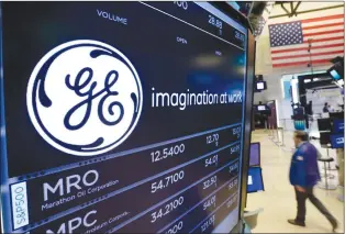  ?? RICHARD DREW/THE ASSOCIATED PRESS ?? In this June 12 file photo, the General Electric logo appears above a trading post on the floor of the New York Stock Exchange.