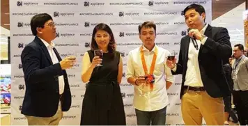  ??  ?? TOAST. SM Appliance Center AVP for Operations Art Young (R) together with SM Appliance Center President Ma. Teresa Cheng (C), Vice President for Operations Tomasito Mendoza (L) and City of San Fernando Councilor Benjamin Jasper Lagman lead a toast...