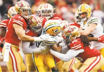  ?? Scott Strazzante / The Chronicle ?? Nick Bosa (97), DeForest Buckner (99) and Sheldon Day stop Green Bay running back Aaron Jones at the line of scrimmage as the 49ers’ defense held the Packers scoreless in the first half.