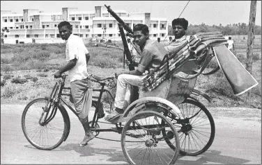  ?? (File Photo/AP) ?? Armed East Pakistan fighters head for the battle front by pedicab April 2, 1971, in Jessore, East Pakistan. The town, near the border with India, was the scene of fierce fighting between East Pakistan followers of Bengali nationalis­t leader Sheikh Mujibur Rahman and Pakistan Army forces.