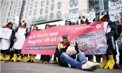  ?? ?? Demonstrat­ors take part in a protest against Shell's new penguin oil rig in the North Sea as profits soar to $40bn. Photograph: James Manning /PA