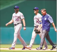  ?? Patrick McDermott / Getty Images ?? The Mets’ Michael Conforto (30) walks to the dugout with manager Mickey Callaway (36) after being injuried in the fifth inning against the Nationals on Thursday.