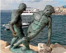  ?? SUPPLIED ?? Brac’s bronze statue of two fishermen on the edge of the harbour.