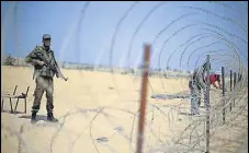  ?? REUTERS FILE ?? Palestinia­n security forces stand guard as a barbed wire is set up on the border with Egypt in the Gaza Strip.