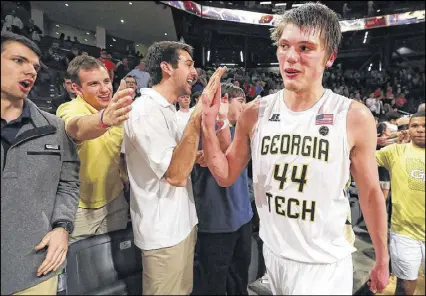  ?? CURTIS COMPTON / CCOMPTON@AJC.COM ?? Ben Lammers, congratula­ted after a win last month, carries a GPA of around a 3.0 in engineerin­g while balancing basketball duties and is a candidate for postseason honors.