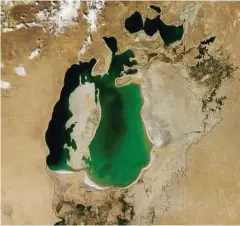  ?? NASA via The New York Times ?? A satellite image of the Aral Sea, with the approximat­e shoreline from 1960 outlined in black.
