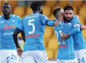  ??  ?? Napoli's Lorenzo Insigne, right, celebrates after scoring during a Serie A soccer match between Napoli and Benevento