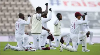  ?? Reuters ?? West Indies players kneel in support of Black Lives Matter before the start of the first Test
