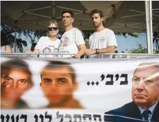  ?? (Olivier Fitoussi/Flash90) ?? LEAH, SIMCHA and Tzur Goldin at a protest in July marking six years to Hadar Goldin’s death and abduction.