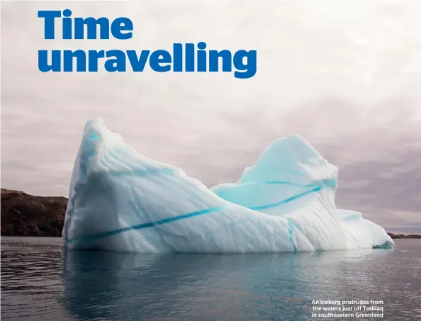  ??  ?? An iceberg protrudes from the waters just off Tasiilaq in southeaste­rn Greenland