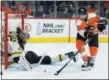  ?? TOM MIHALEK — THE ASSOCIATED PRESS ?? Flyers captain Claude Giroux is about to flick a game-winning backhand shot over stretched Bruins goalie Anton Khudobin, while leaving sprawled Bruin Adam McQuaid in his wake Sunday at Wells Fargo Center.
