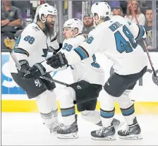  ?? JOHN LOCHER — THE ASSOCIATED PRESS ?? The Sharks’ Logan Couture (39) celebrates his game-winning goal in double overtime with teammates Brent Burns (88) and Tomas Hertl.