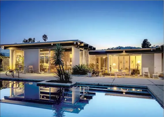  ?? Photog r aphs by Marco Franchina ?? I N BEL- AIR, this Midcentury f lows into a scenic backyard with a swimming pool set among lush gardens. List price: $ 3.495 million.