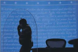  ?? JULIO CORTEZ — THE ASSOCIATED PRESS ?? A member of the production crew walks behind a glass panel at the University of Utah on Tuesday in Salt Lake City amid preparatio­ns for the vice presidenti­al debate.