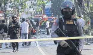  ??  ?? Police stand guard near the site of a blast at the Surabaya Central Pentecost Church in East Java, Indonesia on May 13, 2018. The church was one of five targets of terrorist bombings in which 28 people died.