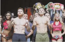  ?? AP PHOTO ?? READY TO FIGHT: Canelo Alvarez (left) and Gennady Golovkin strike a pose yesterday after weighing in for tonight’s middleweig­ht title bout in Las Vegas.