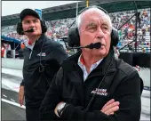  ?? TRIBUNE NEWS SERVICE ?? Team owner Roger Penske, front, and Tim Cindric on qualificat­ion day for the Indianapol­is 500 at the Indianapol­is Motor Speedway on May 19, 2018.