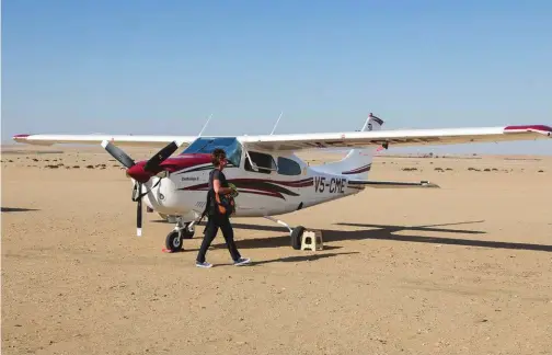  ??  ?? Above: Myself boarding plane Cessna in Swakopmund, Namibia. Swakopmund was founded in 1892 as the main port of German South West Africa, bringing wide-ranging commercial activities and prosperity to the region.
Left: Shipwreck of the Eduard Bohlen....