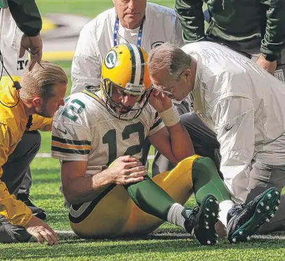  ?? | JIM MONE/ AP ?? Aaron Rodgers was knocked out of the game in the first quarter after taking a hard hit fromViking­s linebacker Anthony Barr.